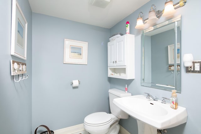 202 Thoroughbred Ln, Nicholasville, KY 40356 - half bathroom with a sink, toilet, and baseboards