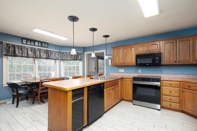 202 Thoroughbred Ln, Nicholasville, KY 40356 - kitchen featuring black appliances, a peninsula, light countertops, and decorative light fixtures