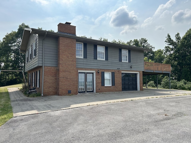 522 Countryside Cir, Mount Vernon, KY 40456 - view of front of property featuring a garage, a chimney, french doors, brick siding, and asphalt driveway