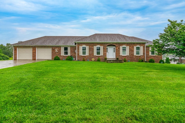 50 Barnett St, Hustonville, KY 40437 - view of front of house with a front yard, an attached garage, driveway, and brick siding
