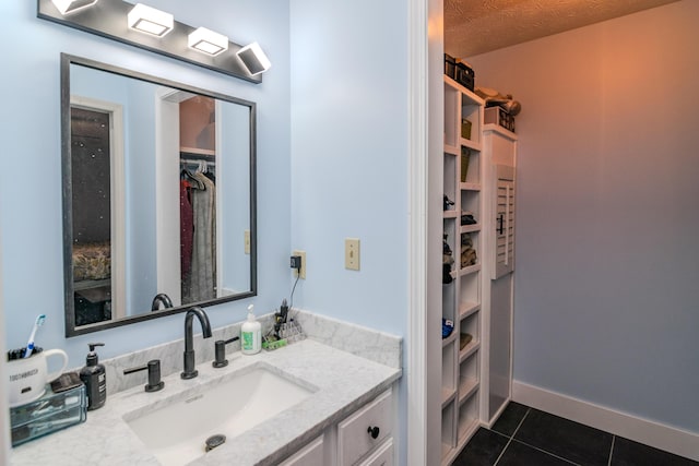 50 Barnett St, Hustonville, KY 40437 - bathroom with tile patterned floors, vanity, and a walk in closet