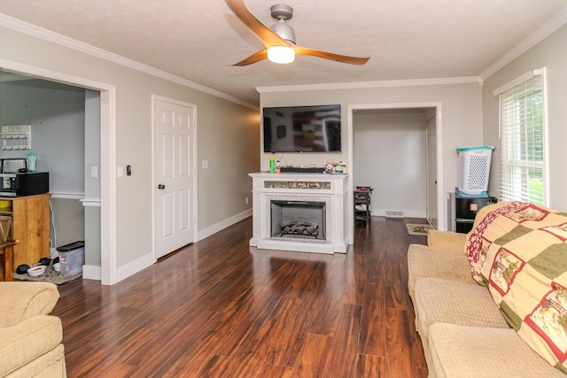 50 Barnett St, Hustonville, KY 40437 - living area with ornamental molding, wood finished floors, a fireplace, and ceiling fan