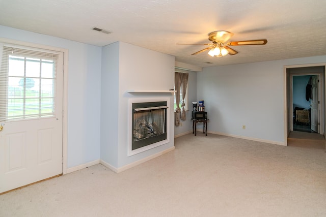 50 Barnett St, Hustonville, KY 40437 - carpeted living room with a fireplace and a ceiling fan