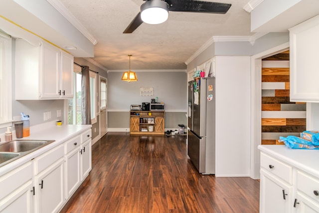 50 Barnett St, Hustonville, KY 40437 - kitchen with stainless steel fridge, a ceiling fan, white cabinetry, dark wood-style flooring, and crown molding