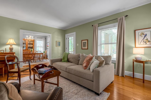 406 Dudley Rd, Lexington, KY 40502 - living room featuring crown molding, light wood-type flooring, baseboards, and a chandelier