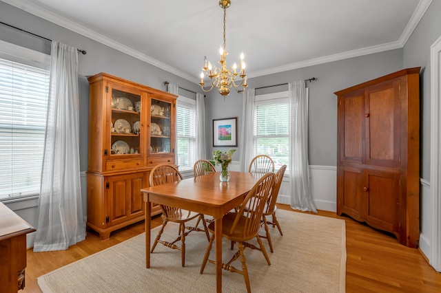 406 Dudley Rd, Lexington, KY 40502 - dining space featuring a chandelier, crown molding, and light wood-style flooring