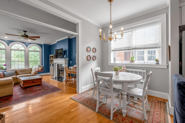 406 Dudley Rd, Lexington, KY 40502 - dining room with a fireplace with flush hearth, wood finished floors, a ceiling fan, crown molding, and baseboards