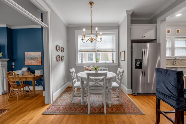 406 Dudley Rd, Lexington, KY 40502 - dining room with a chandelier, light wood-style flooring, plenty of natural light, and crown molding