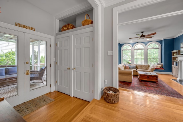 406 Dudley Rd, Lexington, KY 40502 - foyer entrance featuring wood finished floors, french doors, ornamental molding, a ceiling fan, and a fireplace with flush hearth