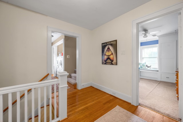 406 Dudley Rd, Lexington, KY 40502 - hallway featuring light wood-style floors, washer and clothes dryer, baseboards, and stairway