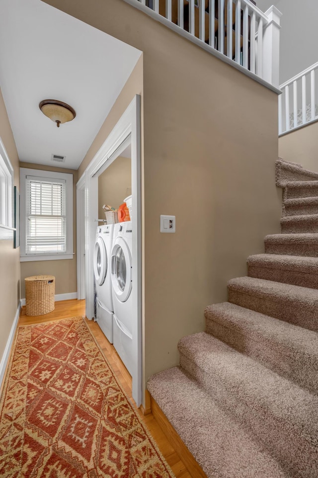 406 Dudley Rd, Lexington, KY 40502 - laundry area with washer and dryer, light wood-style flooring, and baseboards