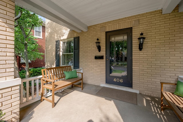 406 Dudley Rd, Lexington, KY 40502 - doorway to property featuring covered porch and brick siding