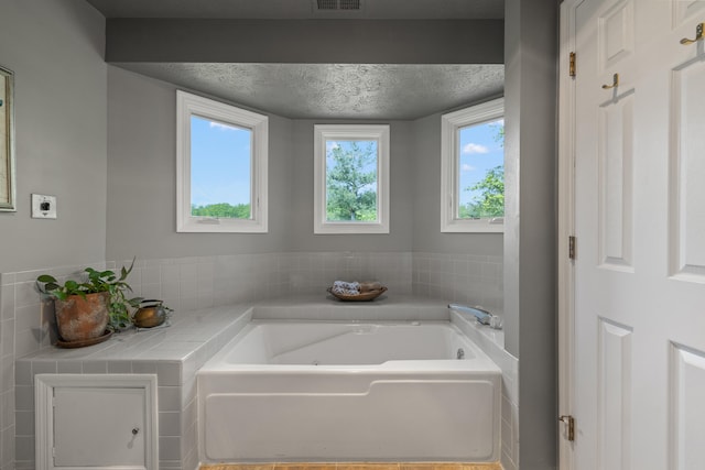 850 Charwood Dr, Lexington, KY 40515 - bathroom featuring a garden tub and a textured ceiling