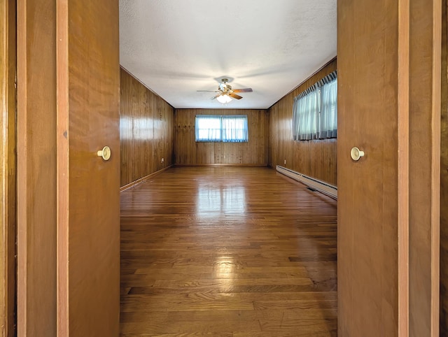 227 Mimosa Ave, Somerset, KY 42503 - spare room with ceiling fan, a baseboard heating unit, hardwood / wood-style flooring, and wood walls