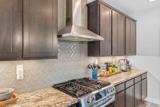 103 Snap Hook Ct, Georgetown, KY 40324 - kitchen featuring wall chimney exhaust hood, stainless steel gas range, dark brown cabinets, decorative backsplash, and light stone counters