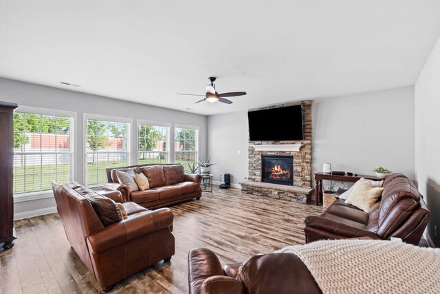 103 Snap Hook Ct, Georgetown, KY 40324 - living area featuring ceiling fan, a stone fireplace, wood finished floors, and baseboards