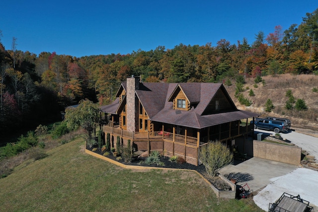 431 Harold Luke Rd, Campton, KY 41301 - rear view of house featuring a forest view, a yard, and a chimney
