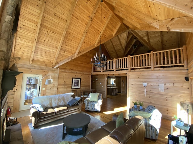 431 Harold Luke Rd, Campton, KY 41301 - living room featuring wood walls, hardwood / wood-style flooring, wood ceiling with exposed beams, high vaulted ceiling, and a chandelier