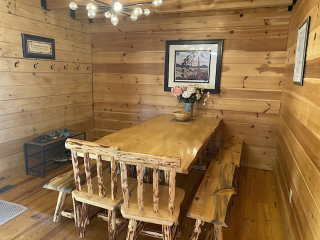 431 Harold Luke Rd, Campton, KY 41301 - dining space featuring a chandelier, wood walls, and hardwood / wood-style floors