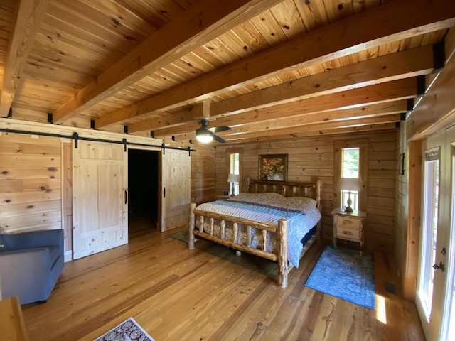 431 Harold Luke Rd, Campton, KY 41301 - bedroom with a barn door, wood walls, light wood-style floors, and wooden ceiling with exposed beams