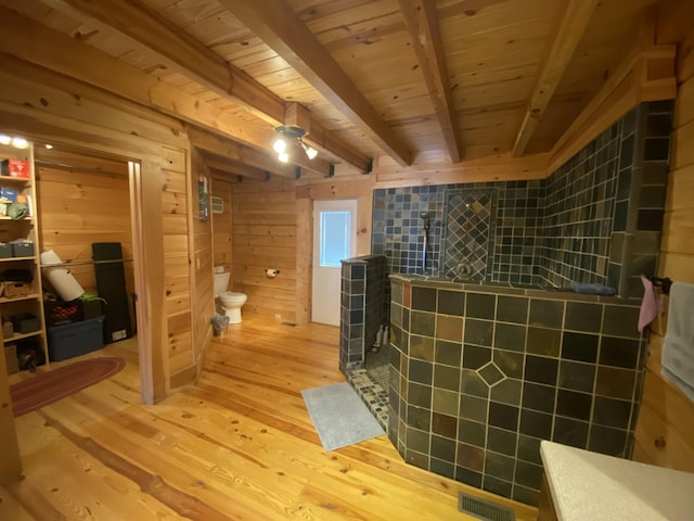 431 Harold Luke Rd, Campton, KY 41301 - full bathroom featuring wood finished floors, toilet, a shower stall, wooden ceiling with exposed beams, and wooden walls