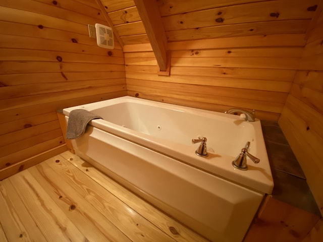431 Harold Luke Rd, Campton, KY 41301 - bathroom with wooden walls and a tub with jets