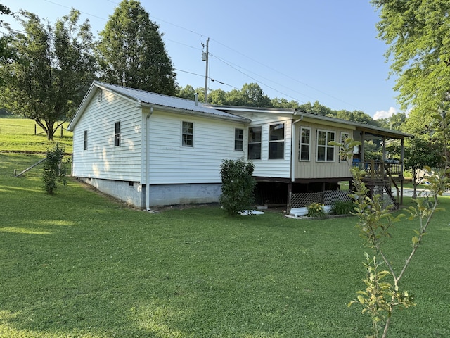 1034 Duncan Valley Rd, Monticello, KY 42633 - back of house featuring a yard, metal roof, and a deck