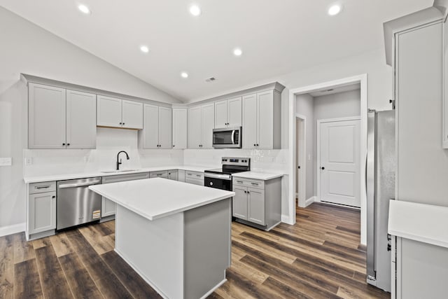 1038 Tamworth Ln, Frankfort, KY 40601 - kitchen with stainless steel appliances, a sink, decorative backsplash, vaulted ceiling, and gray cabinets