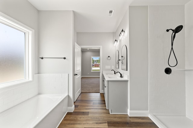1038 Tamworth Ln, Frankfort, KY 40601 - bathroom featuring vanity, a bath, a tile shower, wood finished floors, and baseboards