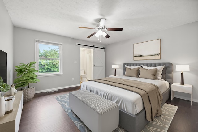 966 Jairus Dr, Lexington, KY 40515 - bedroom with a barn door, baseboards, dark wood-style floors, ensuite bath, and ceiling fan