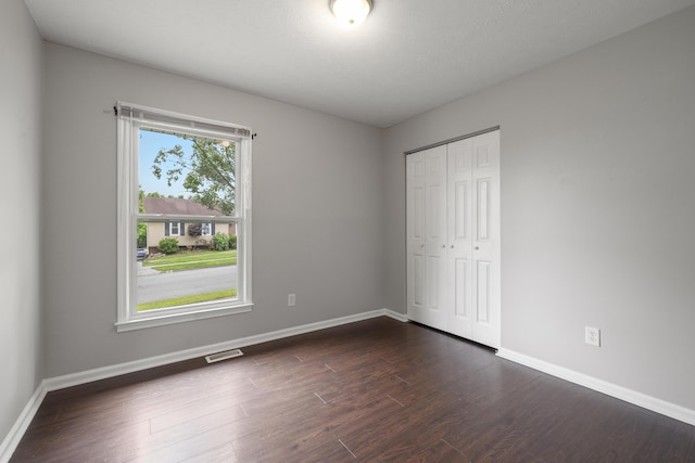 966 Jairus Dr, Lexington, KY 40515 - unfurnished bedroom featuring baseboards, dark wood finished floors, and a closet