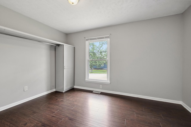 966 Jairus Dr, Lexington, KY 40515 - unfurnished bedroom with baseboards, dark wood finished floors, a closet, and a textured ceiling