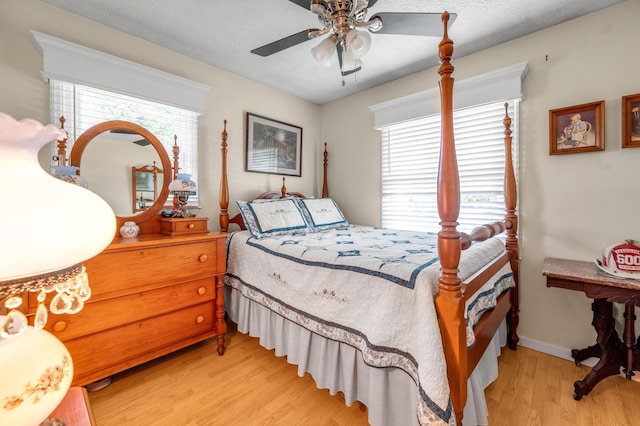 208 Westmoreland Ct, Georgetown, KY 40324 - bedroom featuring light wood finished floors, multiple windows, a ceiling fan, and baseboards