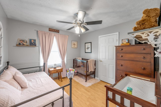 208 Westmoreland Ct, Georgetown, KY 40324 - bedroom with light wood-style floors, a ceiling fan, and a textured ceiling