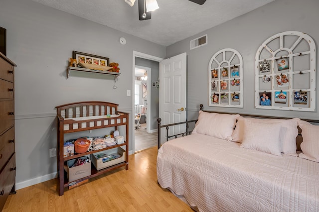 208 Westmoreland Ct, Georgetown, KY 40324 - bedroom featuring light wood-style flooring, baseboards, a textured ceiling, and a ceiling fan
