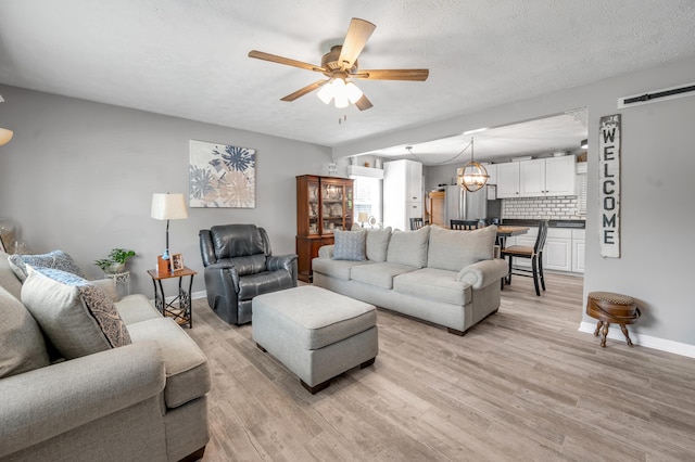 208 Westmoreland Ct, Georgetown, KY 40324 - living area with ceiling fan, light wood finished floors, baseboards, and a chandelier