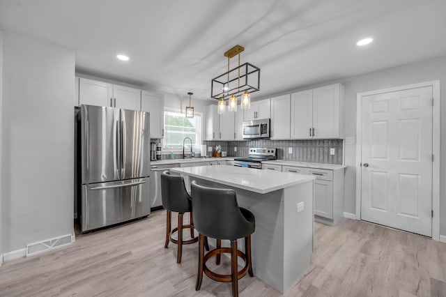 1626 Raleigh Rd, Lexington, KY 40505 - kitchen featuring appliances with stainless steel finishes, tasteful backsplash, light countertops, light wood-style flooring, and recessed lighting