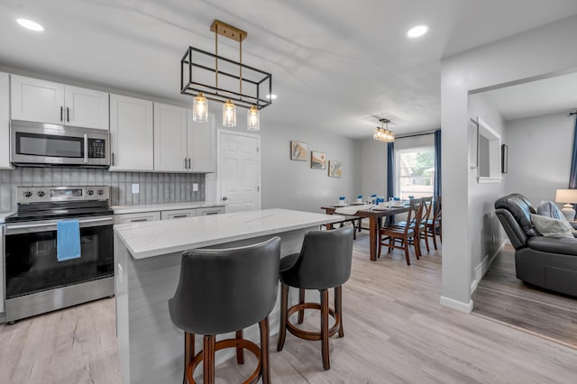 1626 Raleigh Rd, Lexington, KY 40505 - kitchen with stainless steel appliances, decorative backsplash, light wood-style floors, and recessed lighting