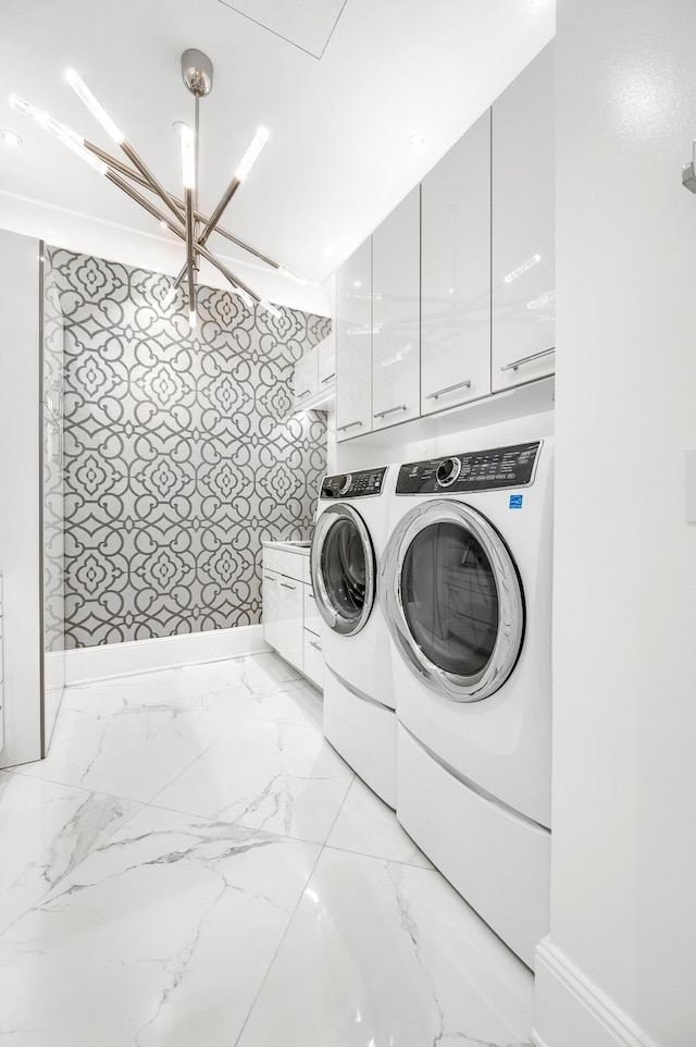 103 S Limestone St Unit 1150, Lexington, KY 40507 - laundry area featuring cabinet space, washing machine and clothes dryer, light marble finish floors, and baseboards