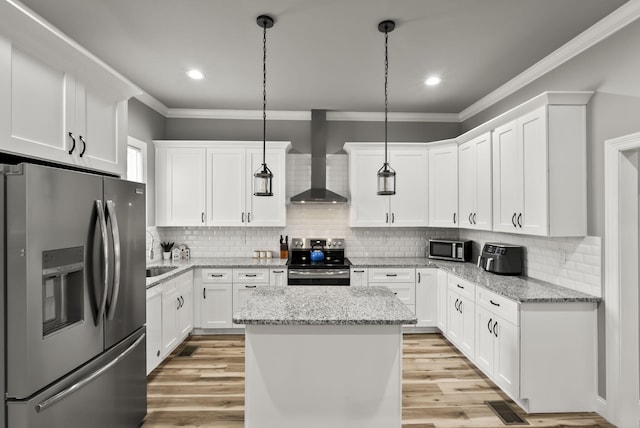 559 Breckenridge St, Lexington, KY 40508 - kitchen with appliances with stainless steel finishes, wall chimney range hood, crown molding, white cabinetry, and a center island
