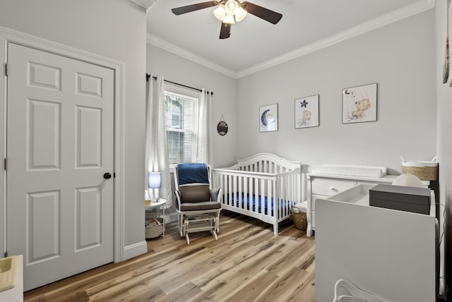 559 Breckenridge St, Lexington, KY 40508 - bedroom with ornamental molding, a nursery area, light wood-style floors, and ceiling fan