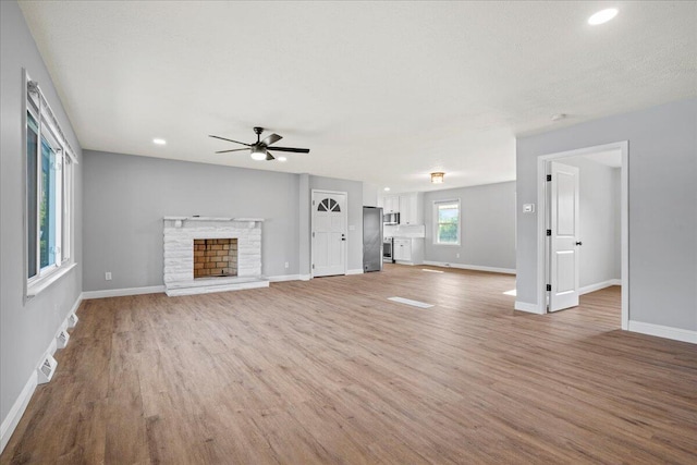 113 Buckwood Dr, Richmond, KY 40475 - unfurnished living room featuring light wood-style flooring, a ceiling fan, baseboards, a fireplace, and recessed lighting