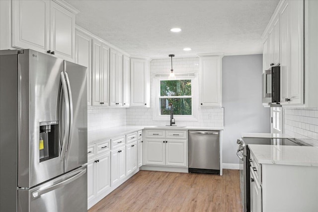 113 Buckwood Dr, Richmond, KY 40475 - kitchen with appliances with stainless steel finishes, a sink, a textured ceiling, white cabinets, and backsplash