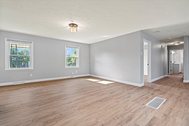 113 Buckwood Dr, Richmond, KY 40475 - spare room featuring light wood-style floors, healthy amount of natural light, baseboards, and a textured ceiling