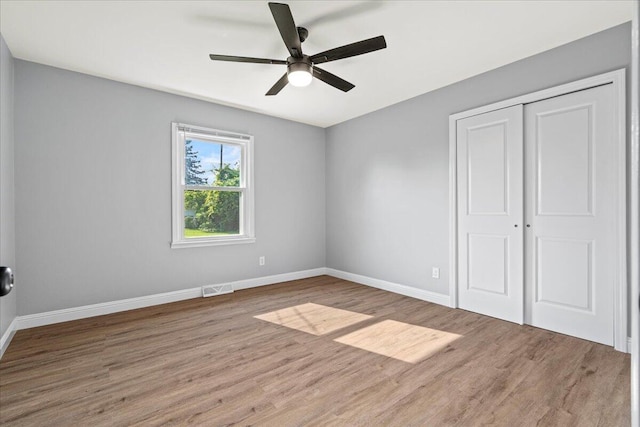 113 Buckwood Dr, Richmond, KY 40475 - unfurnished bedroom with wood finished floors, baseboards, a closet, and a ceiling fan