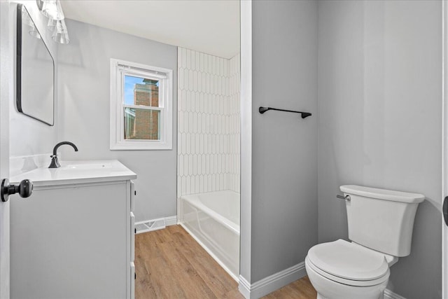 113 Buckwood Dr, Richmond, KY 40475 - bathroom featuring vanity, baseboards, wood finished floors, toilet, and shower / bath combination