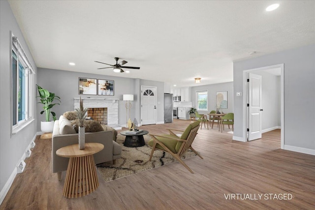 113 Buckwood Dr, Richmond, KY 40475 - living area featuring baseboards, a stone fireplace, light wood-style flooring, a ceiling fan, and recessed lighting