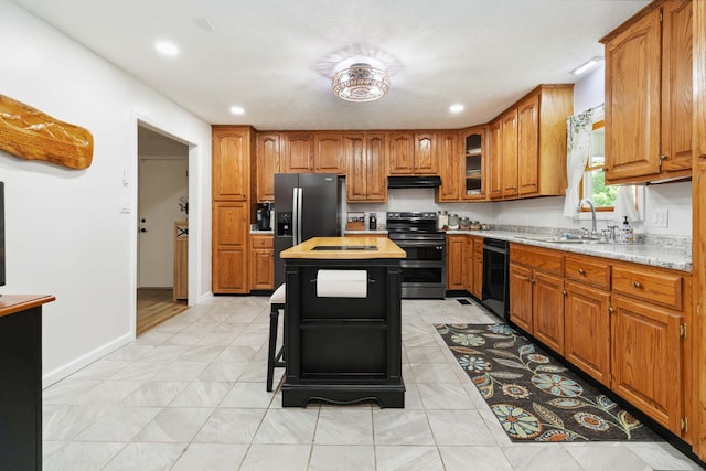 21 Vicki St, Nancy, KY 42544 - kitchen featuring stainless steel appliances, under cabinet range hood, a sink, brown cabinetry, and a center island