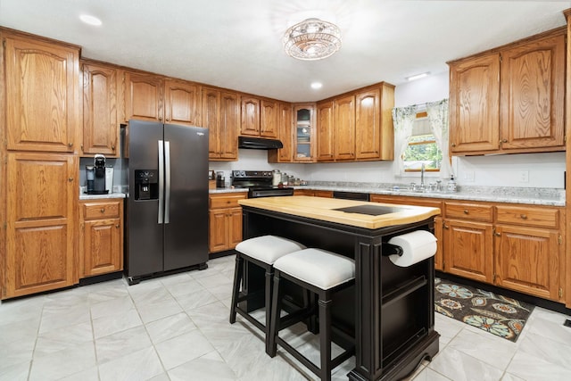 21 Vicki St, Nancy, KY 42544 - kitchen featuring black appliances, under cabinet range hood, brown cabinets, and light countertops