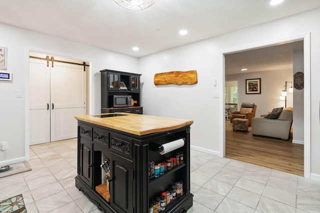 21 Vicki St, Nancy, KY 42544 - kitchen with wooden counters, dark cabinetry, a barn door, light tile patterned flooring, and open shelves